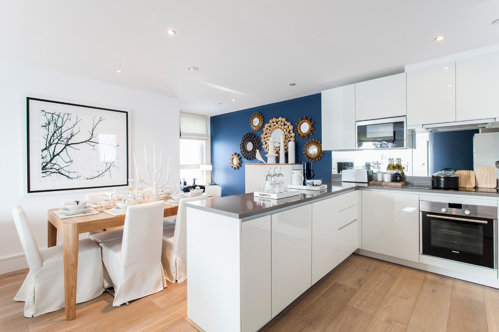Kitchen - contemporary kitchen idea in London with flat-panel cabinets