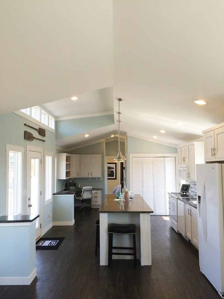 Example of a small arts and crafts linoleum floor eat-in kitchen design in Other with shaker cabinets, white cabinets, white appliances and an island