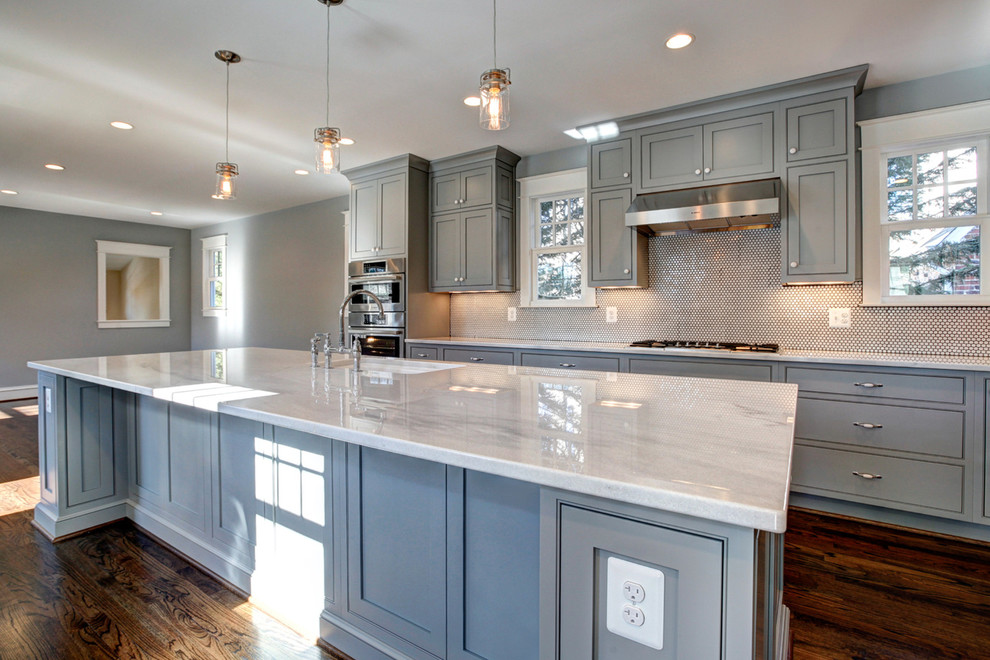Inspiration for a mid-sized craftsman l-shaped medium tone wood floor open concept kitchen remodel in DC Metro with a single-bowl sink, beaded inset cabinets, gray cabinets, quartzite countertops, white backsplash, mosaic tile backsplash, white appliances and two islands
