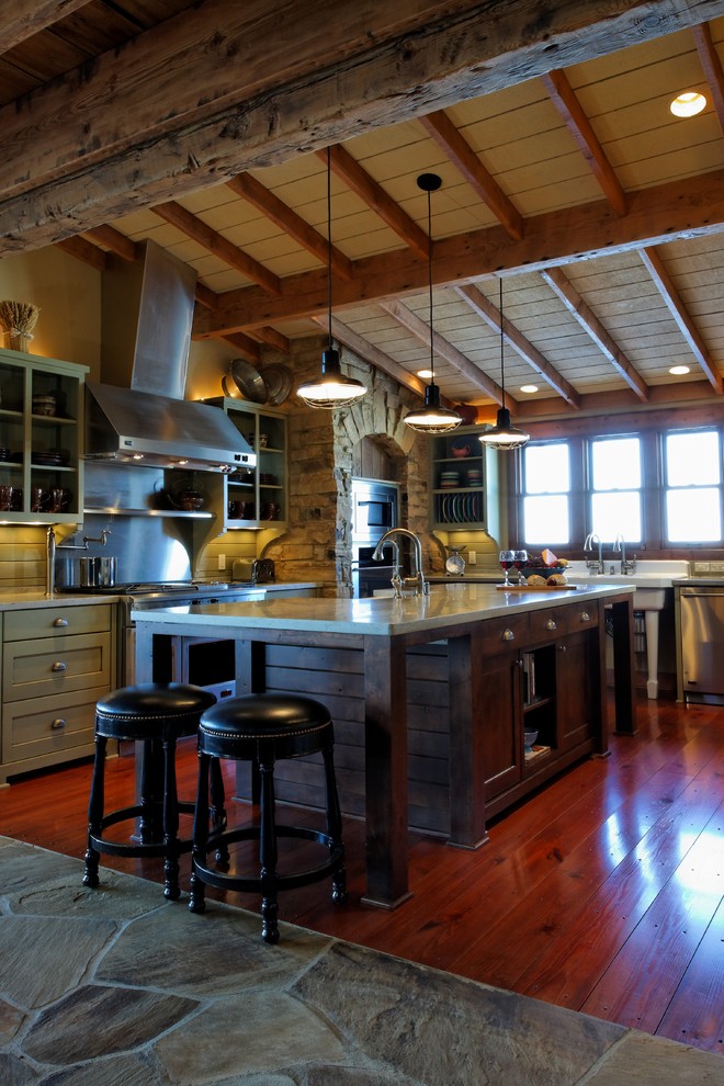 Example of a huge mountain style u-shaped medium tone wood floor eat-in kitchen design in Omaha with a farmhouse sink, gray cabinets, quartz countertops, gray backsplash, stainless steel appliances and an island