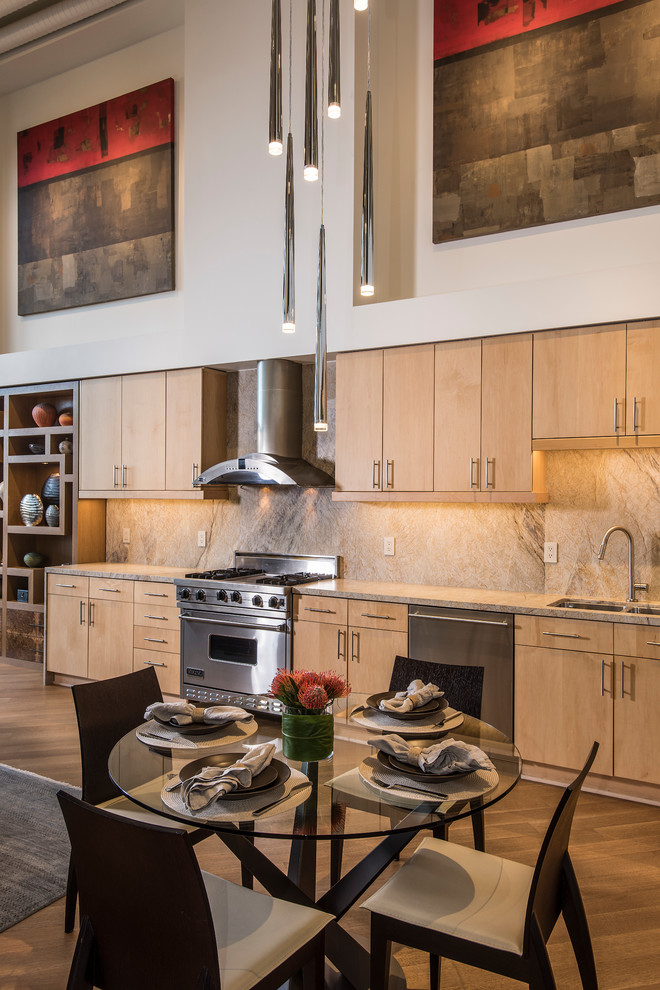 Example of a small trendy single-wall medium tone wood floor and brown floor open concept kitchen design in Phoenix with an undermount sink, flat-panel cabinets, light wood cabinets, quartzite countertops, stone slab backsplash, stainless steel appliances, no island and brown backsplash
