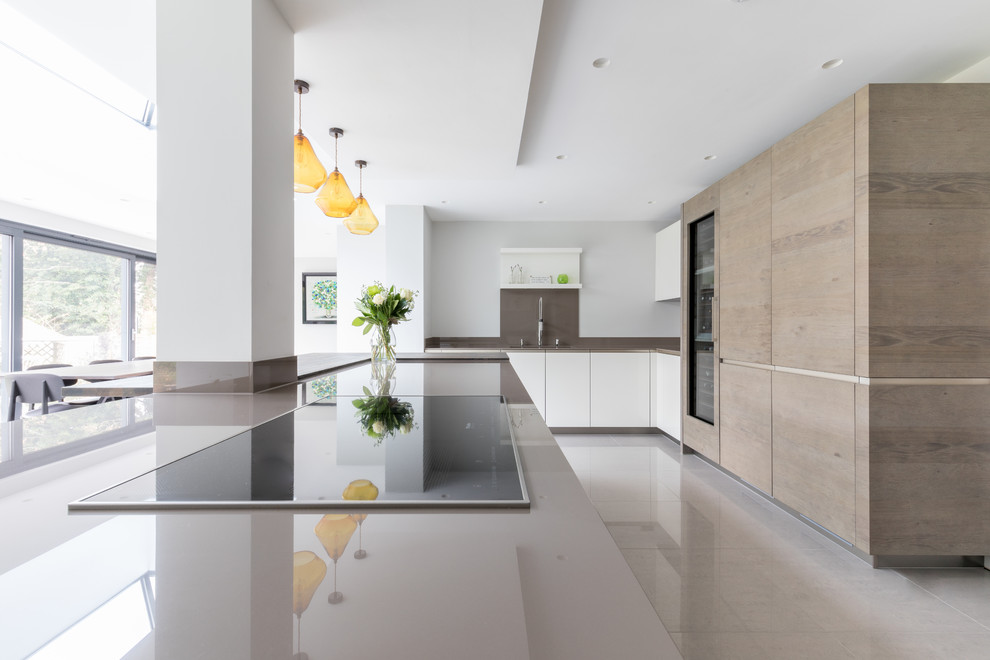 Design ideas for a large contemporary galley open plan kitchen in Sussex with flat-panel cabinets and an island.