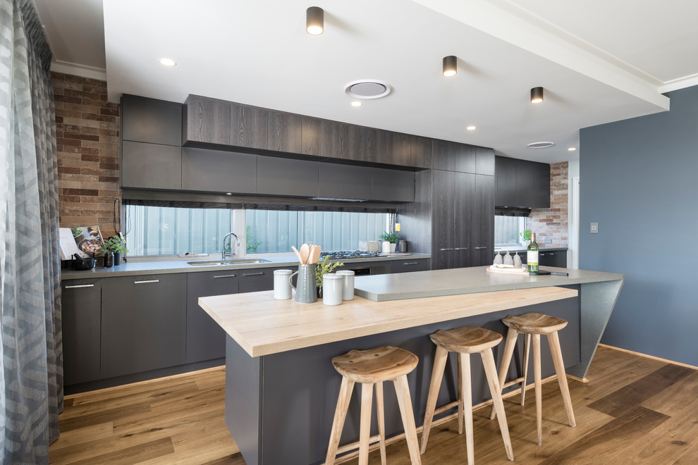 Beach style kitchen in Perth with grey cabinets, light hardwood flooring and beige floors.