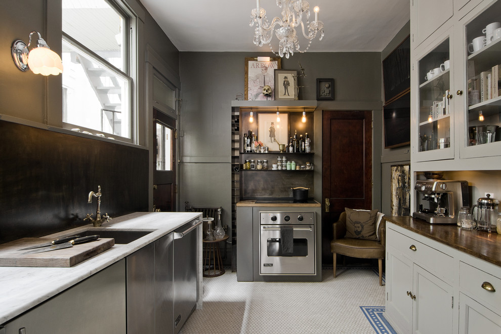 Photo of a small eclectic kitchen in Salt Lake City with a submerged sink, glass-front cabinets, grey cabinets, stainless steel appliances, no island, marble worktops, brown splashback and ceramic flooring.