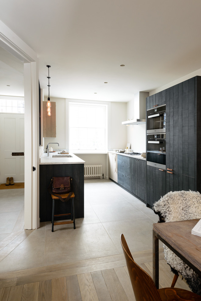 Inspiration for a small contemporary galley light wood floor eat-in kitchen remodel in London with an integrated sink, flat-panel cabinets, granite countertops, paneled appliances and no island