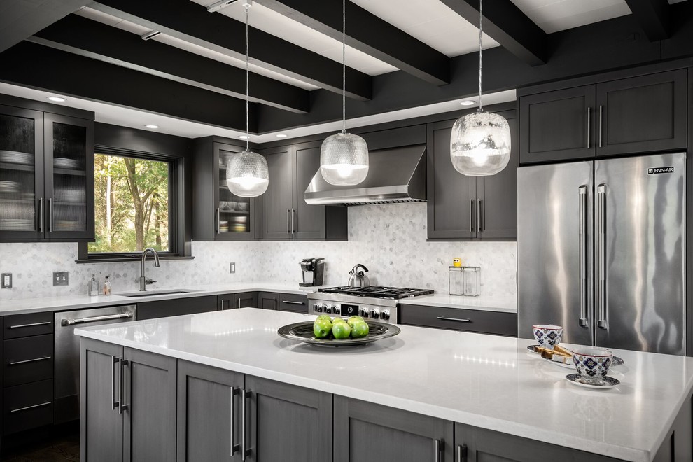Transitional l-shaped kitchen photo in Philadelphia with an undermount sink, shaker cabinets, multicolored backsplash, stainless steel appliances and an island