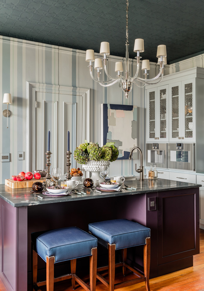 Design ideas for a small traditional enclosed kitchen in Boston with a submerged sink, purple cabinets, soapstone worktops, stainless steel appliances, medium hardwood flooring, an island, brown floors and shaker cabinets.