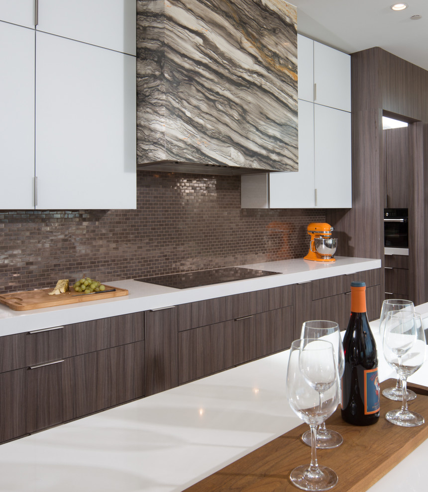 Inspiration for a large contemporary l-shaped open plan kitchen in Sacramento with a submerged sink, flat-panel cabinets, dark wood cabinets, engineered stone countertops, metallic splashback, mosaic tiled splashback, stainless steel appliances, porcelain flooring and an island.