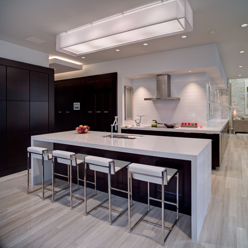 This is an example of a contemporary galley kitchen in Orlando with a submerged sink, flat-panel cabinets and white splashback.