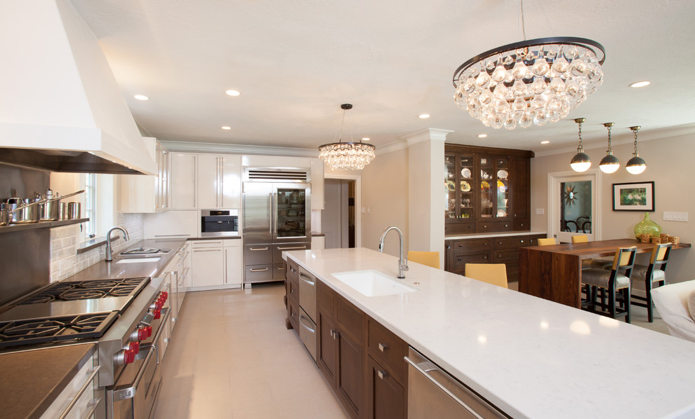 Example of a classic l-shaped open concept kitchen design in Houston with a single-bowl sink, white cabinets, quartz countertops, white backsplash, subway tile backsplash, stainless steel appliances, an island and flat-panel cabinets