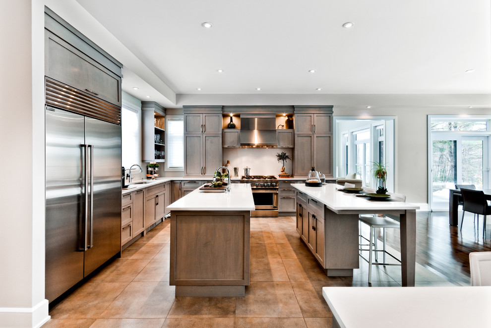 This is an example of a traditional kitchen in Montreal with stainless steel appliances and multiple islands.