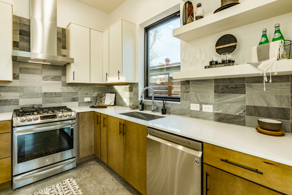 Modern inredning av ett mellanstort vit vitt kök, med en undermonterad diskho, släta luckor, skåp i mellenmörkt trä, bänkskiva i kvarts, grått stänkskydd, stänkskydd i marmor, rostfria vitvaror, betonggolv, en köksö och grått golv