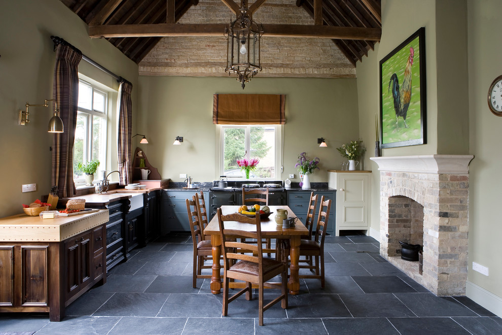 Large farmhouse l-shaped slate floor eat-in kitchen photo in Other with a farmhouse sink, recessed-panel cabinets, gray cabinets, no island and black appliances