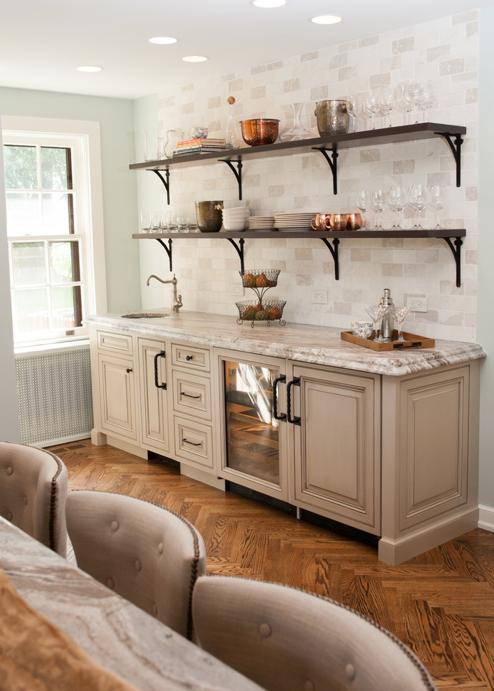 Example of a large classic l-shaped medium tone wood floor enclosed kitchen design in Philadelphia with a farmhouse sink, raised-panel cabinets, granite countertops, beige backsplash, paneled appliances and an island