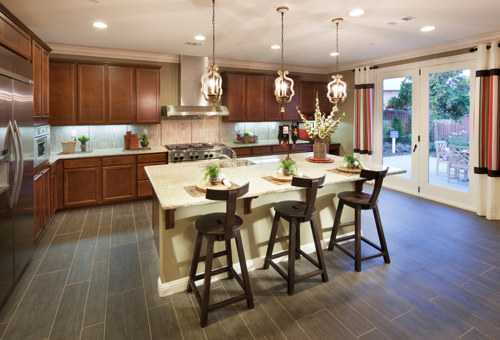 Example of a trendy l-shaped kitchen design in San Diego with recessed-panel cabinets and medium tone wood cabinets