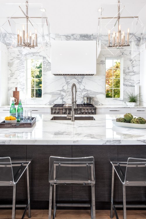 Inspiration for a traditional l-shaped kitchen/diner in Charlotte with a submerged sink, flat-panel cabinets, white cabinets, marble worktops, white splashback, marble splashback, stainless steel appliances, light hardwood flooring and no island.