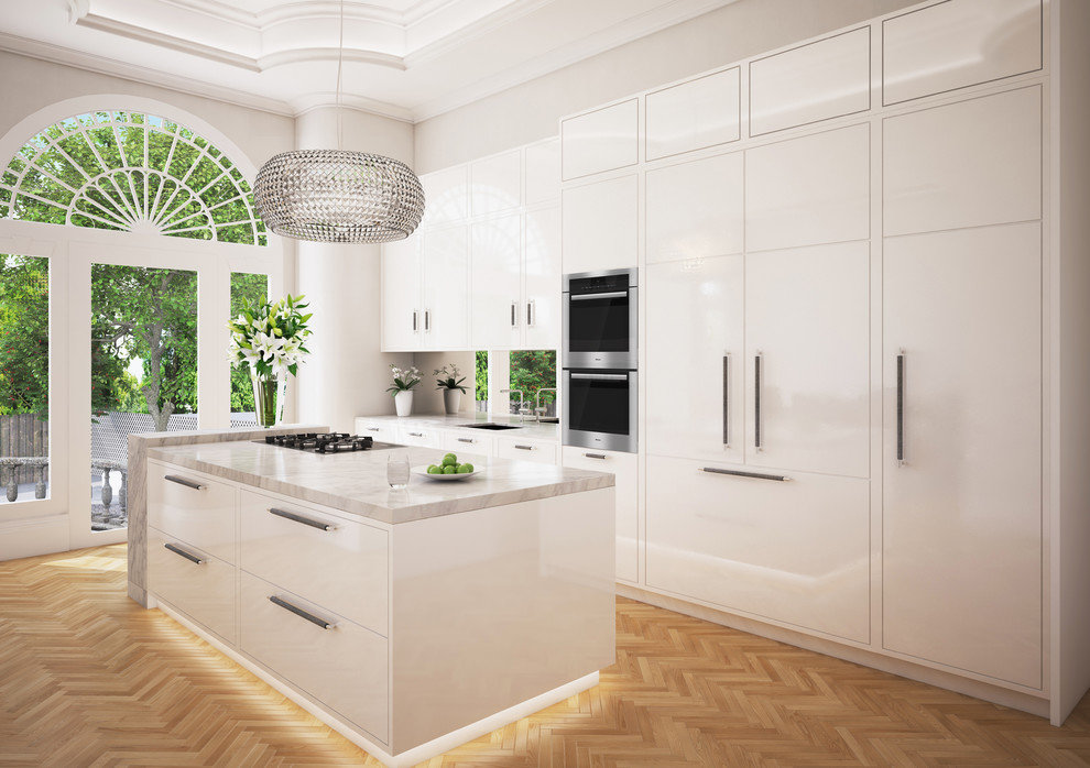 Photo of a medium sized traditional kitchen/diner in Other with an integrated sink, flat-panel cabinets, white cabinets, marble worktops, mirror splashback, integrated appliances, light hardwood flooring and an island.
