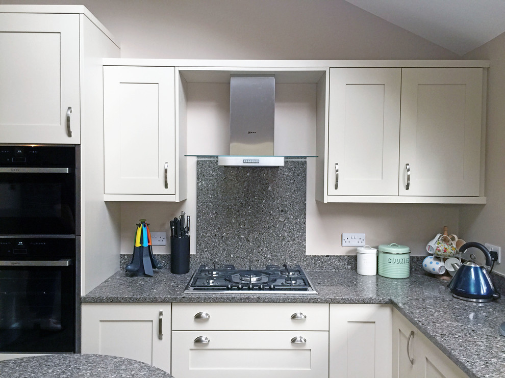 This is an example of a medium sized contemporary l-shaped enclosed kitchen in Other with an integrated sink, shaker cabinets, quartz worktops and an island.