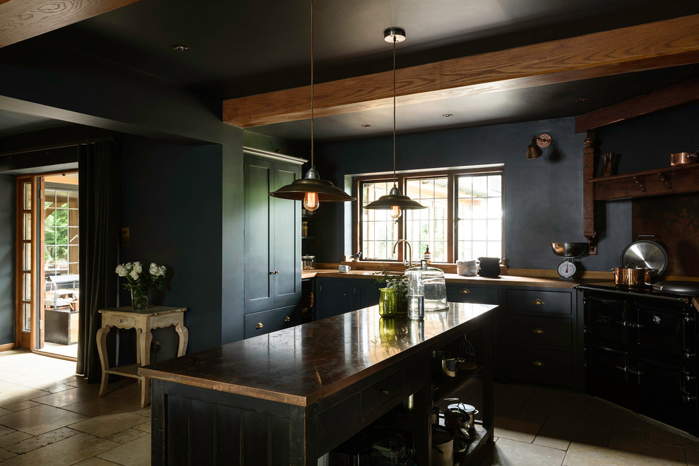Inspiration for a mid-sized farmhouse terra-cotta tile kitchen remodel in London with an undermount sink, shaker cabinets, black cabinets and an island