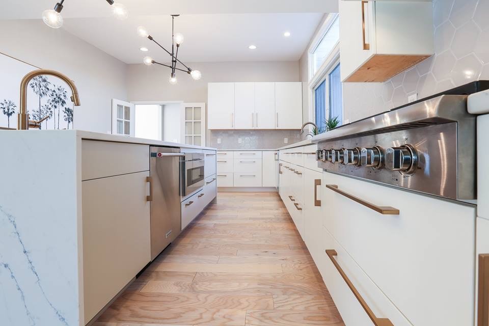 Enclosed kitchen - large contemporary l-shaped light wood floor and beige floor enclosed kitchen idea in Baltimore with an undermount sink, flat-panel cabinets, white cabinets, marble countertops, gray backsplash, ceramic backsplash, stainless steel appliances, an island and white countertops