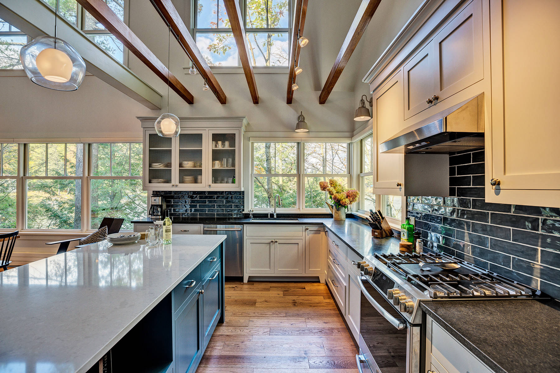 Gorgeous two story kitchen, granite countertops, pendant lighting, blue  mosaic backsplash tile, g…