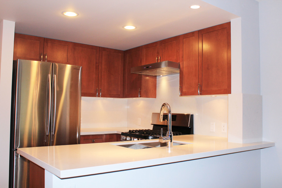 Example of a minimalist u-shaped porcelain tile eat-in kitchen design in Vancouver with an undermount sink, shaker cabinets, medium tone wood cabinets, quartzite countertops, white backsplash, stone slab backsplash and stainless steel appliances