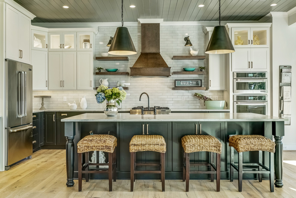 Inspiration for a huge cottage l-shaped light wood floor and brown floor open concept kitchen remodel in Richmond with a farmhouse sink, shaker cabinets, white backsplash, subway tile backsplash, stainless steel appliances and an island