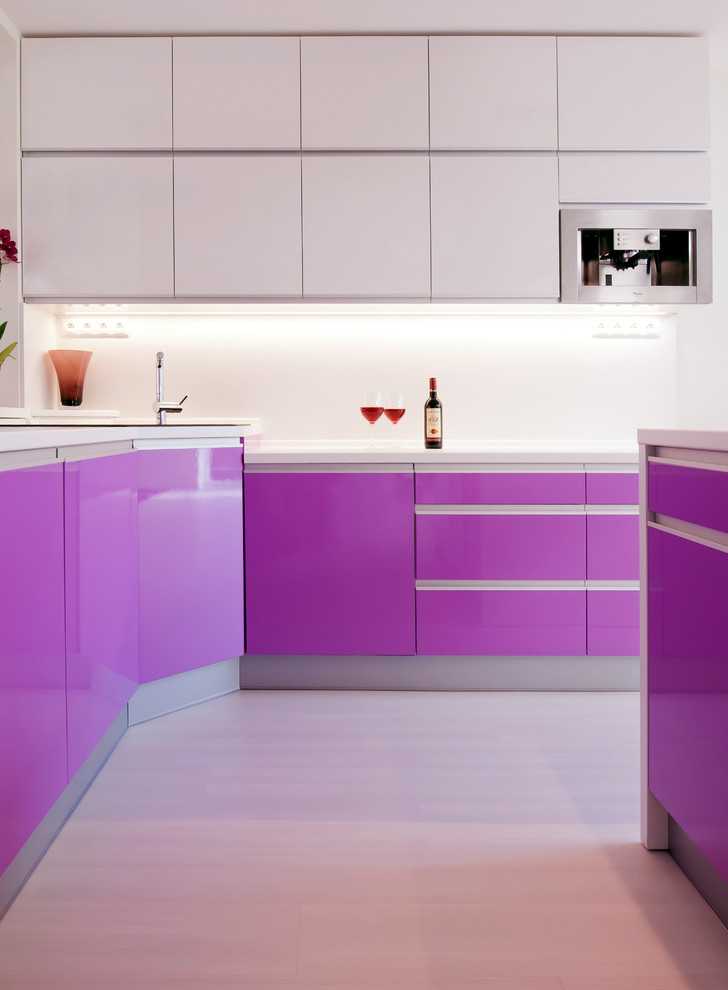 Example of a minimalist kitchen design in Other with flat-panel cabinets and stainless steel appliances
