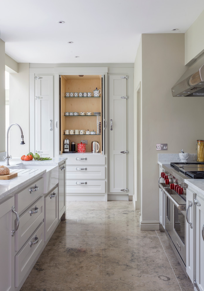 Inspiration for a mid-sized transitional kitchen remodel in Wiltshire with a farmhouse sink, shaker cabinets, gray cabinets and an island