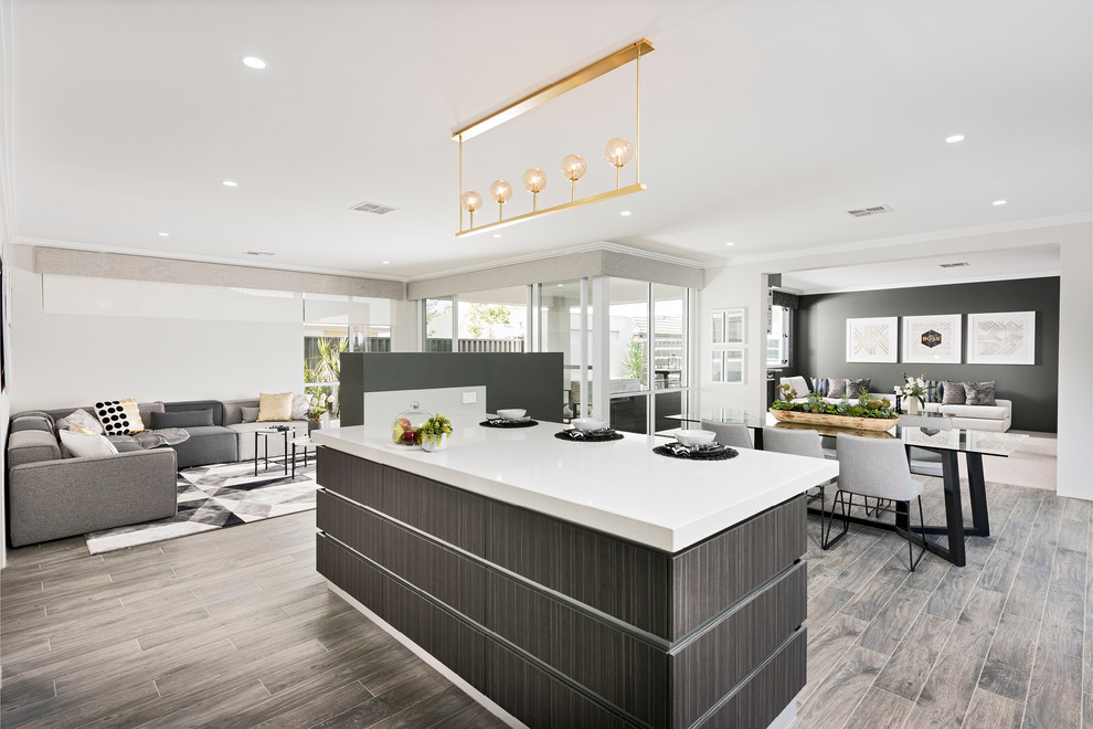 Large modern galley open plan kitchen in Perth with a double-bowl sink, flat-panel cabinets, dark wood cabinets, engineered stone countertops, glass sheet splashback, stainless steel appliances, porcelain flooring and an island.