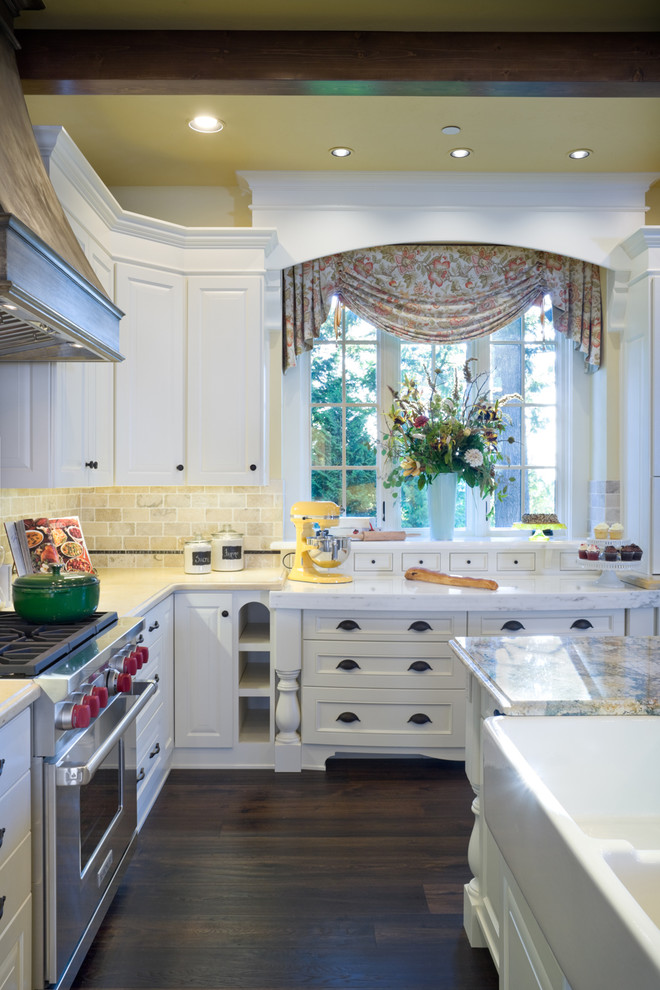 Elegant kitchen photo in Portland with stainless steel appliances and a farmhouse sink