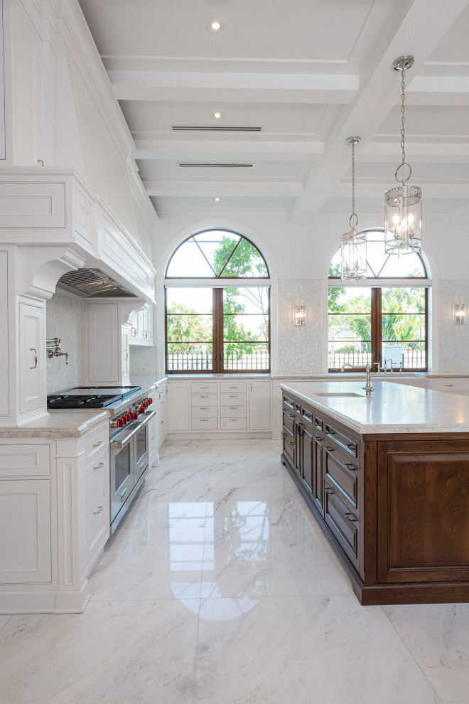 Inspiration for an expansive traditional u-shaped kitchen/diner in Miami with a belfast sink, shaker cabinets, white cabinets, granite worktops, grey splashback, stainless steel appliances, marble flooring, an island, grey floors and beige worktops.