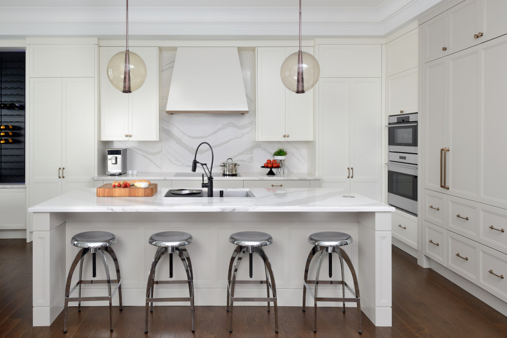 Kitchen - mid-sized transitional dark wood floor, brown floor and coffered ceiling kitchen idea in Toronto with an undermount sink, recessed-panel cabinets, white cabinets, quartz countertops, white backsplash, quartz backsplash, paneled appliances, an island and white countertops
