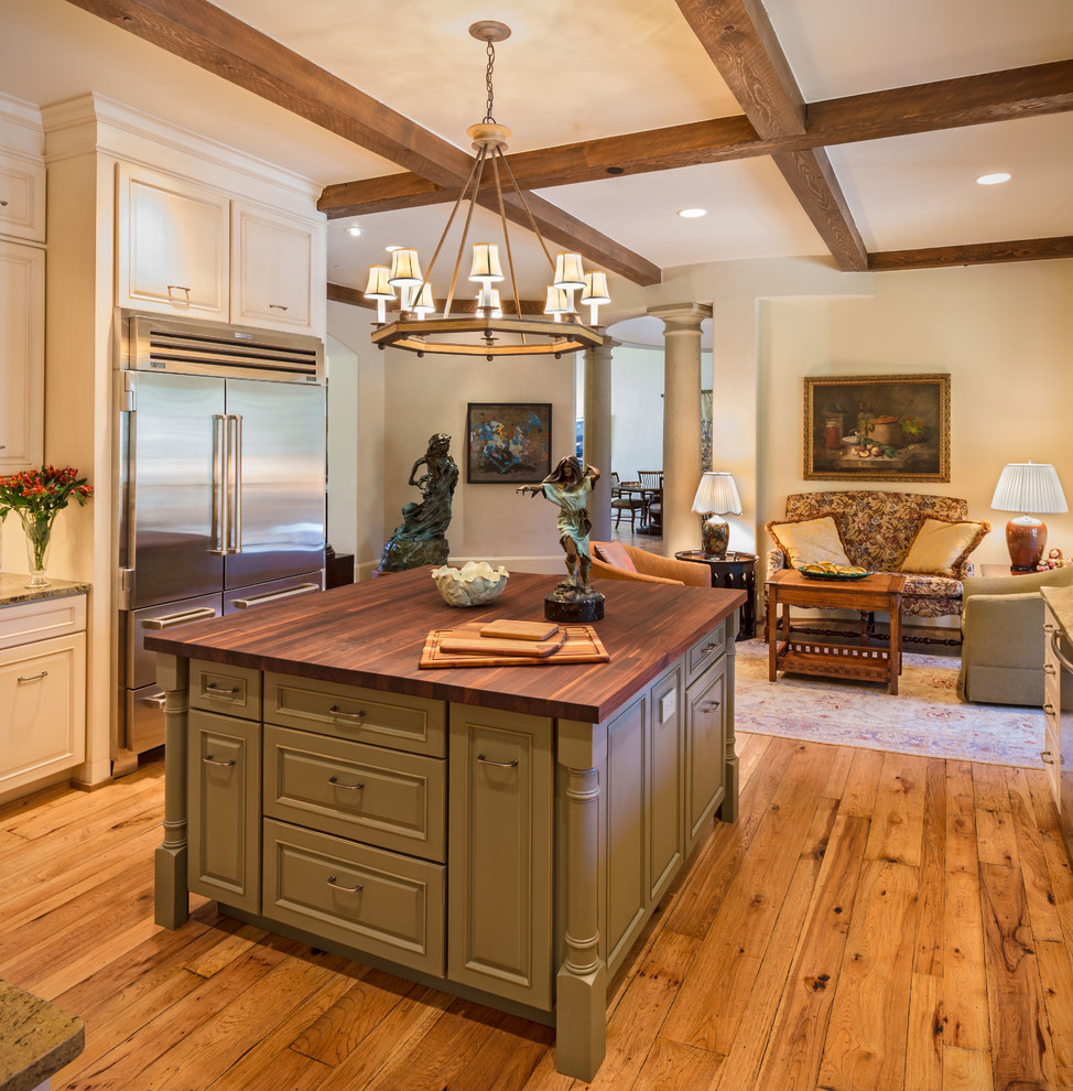 Inspiration for a large traditional u-shaped kitchen pantry in Albuquerque with a double-bowl sink, raised-panel cabinets, distressed cabinets, wood worktops, stainless steel appliances and medium hardwood flooring.