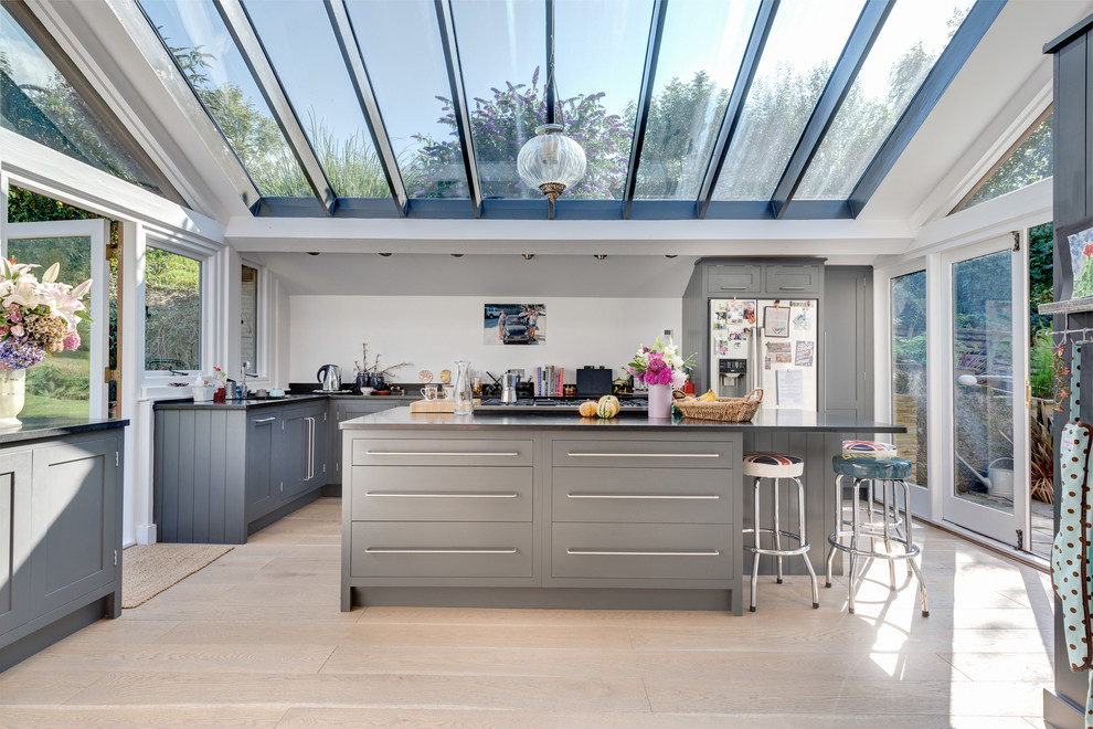 Design ideas for a contemporary l-shaped kitchen in Devon with flat-panel cabinets, grey cabinets and stainless steel appliances.