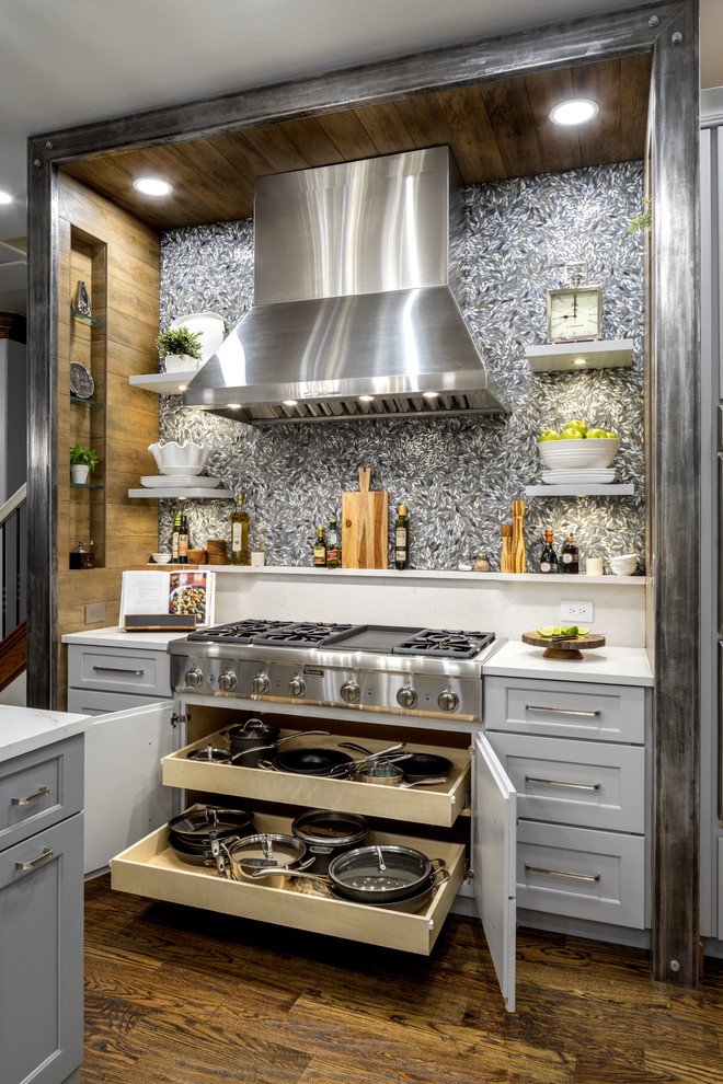 Inspiration for a large transitional medium tone wood floor and brown floor open concept kitchen remodel in Oklahoma City with a single-bowl sink, shaker cabinets, gray cabinets, quartz countertops, gray backsplash, porcelain backsplash, stainless steel appliances and an island