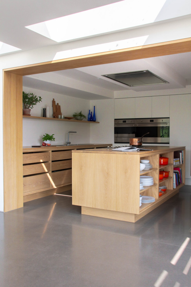 Photo of a large scandinavian galley open plan kitchen in Other with a double-bowl sink, open cabinets, light wood cabinets, wood worktops, stainless steel appliances, an island and grey floors.