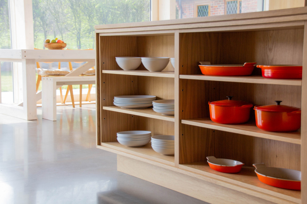 Photo of a large scandi galley open plan kitchen in Other with a double-bowl sink, open cabinets, light wood cabinets, wood worktops, stainless steel appliances, an island and grey floors.