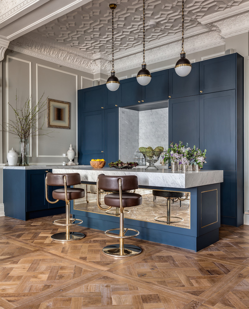 Kitchen - eclectic kitchen idea in London with shaker cabinets, blue cabinets, marble countertops and an island