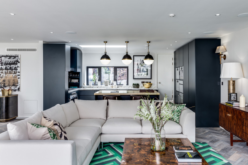 Inspiration for a contemporary l-shaped light wood floor eat-in kitchen remodel in London with flat-panel cabinets, black cabinets and an island