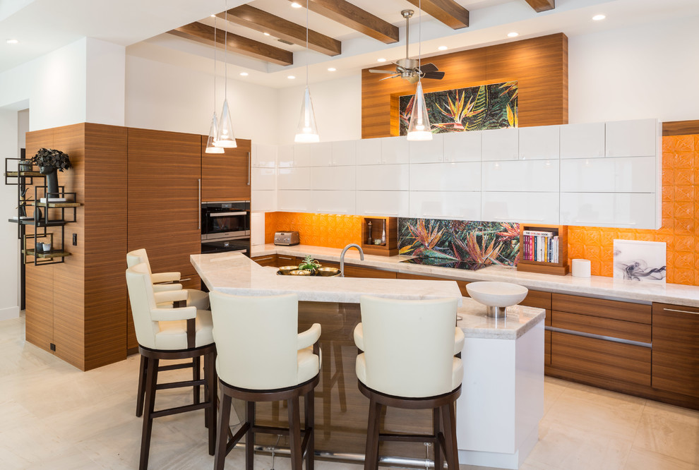 Inspiration for a medium sized classic l-shaped kitchen in Tampa with a submerged sink, flat-panel cabinets, medium wood cabinets, granite worktops, orange splashback, stainless steel appliances and an island.