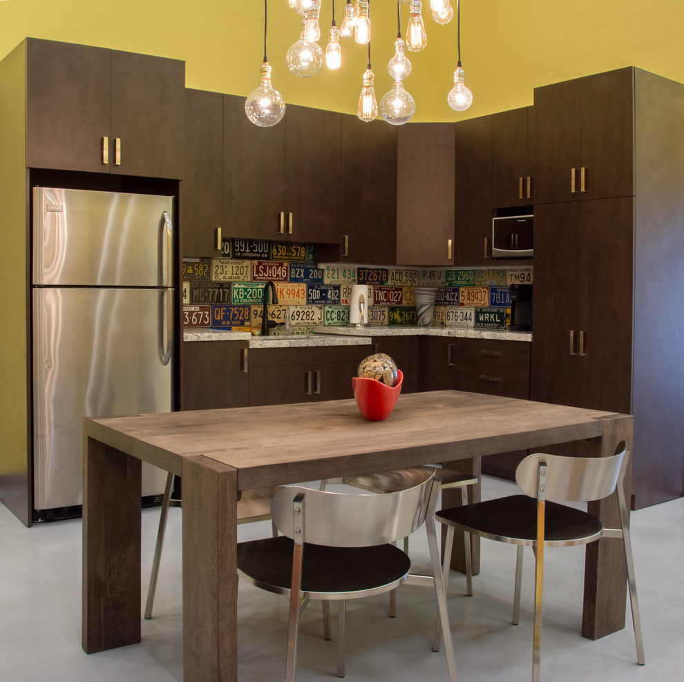 Eat-in kitchen - mid-sized industrial l-shaped concrete floor eat-in kitchen idea in Miami with an undermount sink, flat-panel cabinets, dark wood cabinets, granite countertops, multicolored backsplash, stainless steel appliances and no island