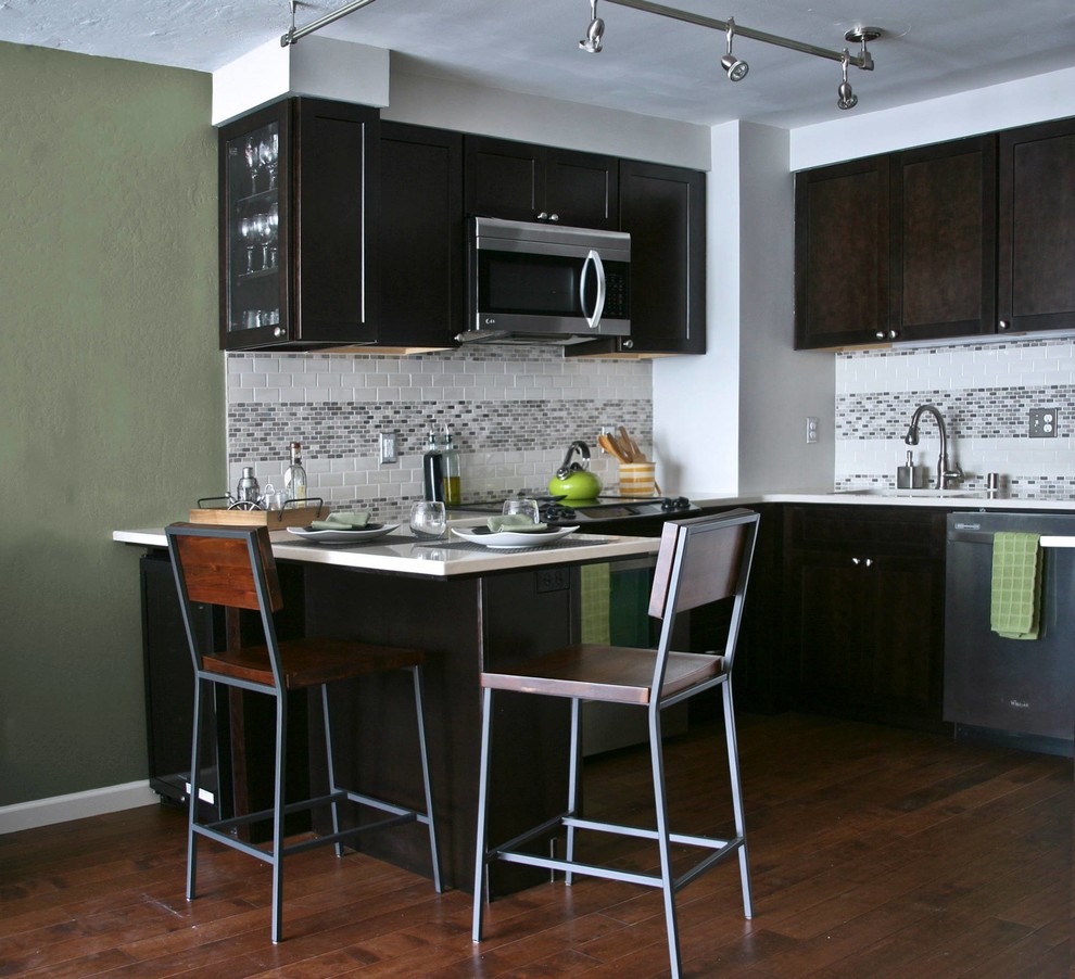 Eat-in kitchen - small transitional u-shaped dark wood floor eat-in kitchen idea in San Francisco with a drop-in sink, recessed-panel cabinets, dark wood cabinets, metallic backsplash, ceramic backsplash, stainless steel appliances and a peninsula