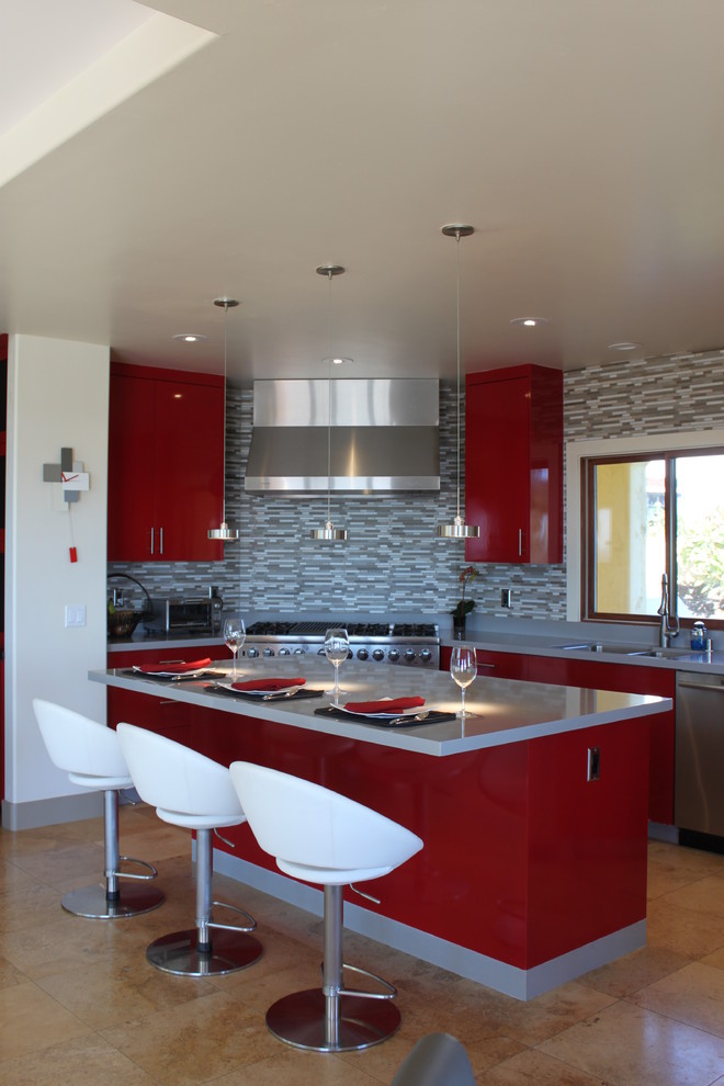 Eat-in kitchen - large contemporary u-shaped travertine floor eat-in kitchen idea in San Diego with a double-bowl sink, flat-panel cabinets, red cabinets, quartzite countertops, gray backsplash, mosaic tile backsplash, stainless steel appliances and an island