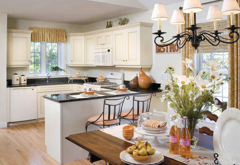 Transitional u-shaped eat-in kitchen photo in Boston with shaker cabinets, beige cabinets, black backsplash and white appliances