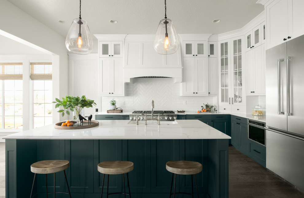 Kitchen - coastal l-shaped dark wood floor and brown floor kitchen idea in Boise with shaker cabinets, white cabinets, white backsplash, stainless steel appliances and an island