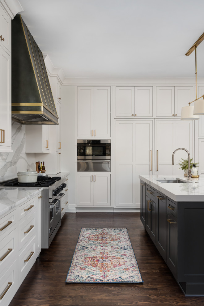 Large transitional l-shaped dark wood floor, brown floor and coffered ceiling open concept kitchen photo in Chicago with an undermount sink, flat-panel cabinets, white cabinets, quartz countertops, white backsplash, quartz backsplash, paneled appliances, two islands and white countertops