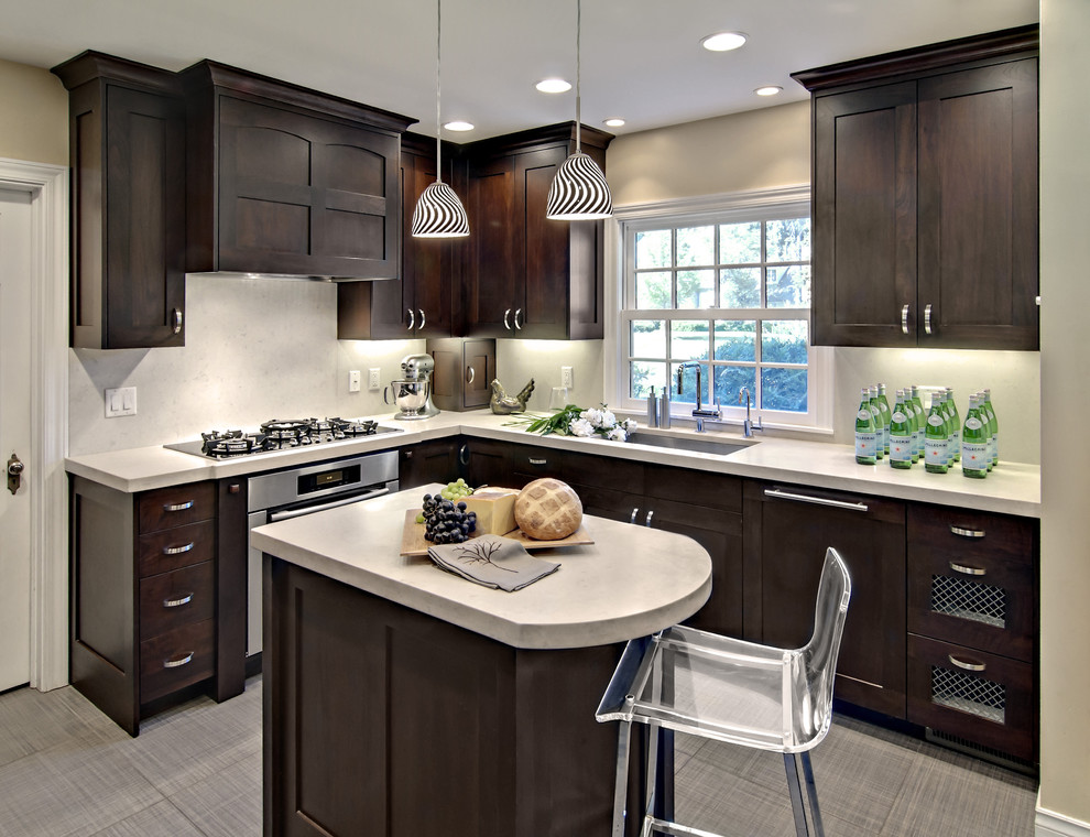 Inspiration for a mid-sized contemporary l-shaped eat-in kitchen remodel in Minneapolis with dark wood cabinets, recessed-panel cabinets, white backsplash and paneled appliances