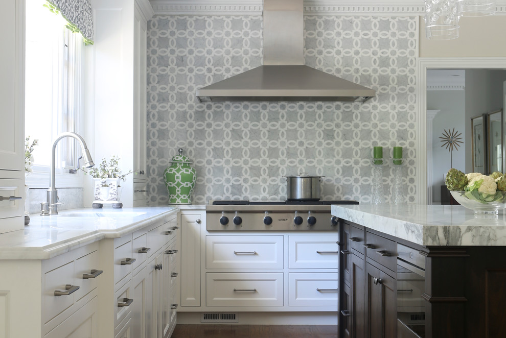 Example of a large transitional galley medium tone wood floor kitchen design in New York with a single-bowl sink, recessed-panel cabinets, white cabinets, marble countertops, multicolored backsplash, mosaic tile backsplash, stainless steel appliances and an island