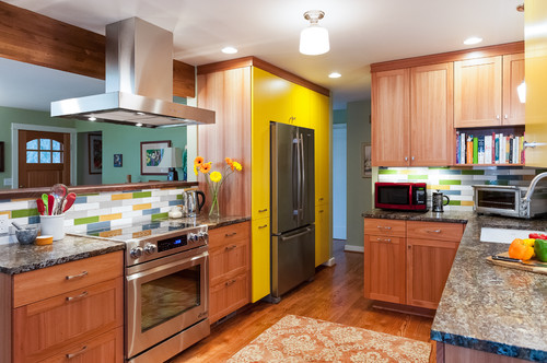 Modern kitchen with wooden RTA Cabinets, stainless steel appliances, and colorful backsplash